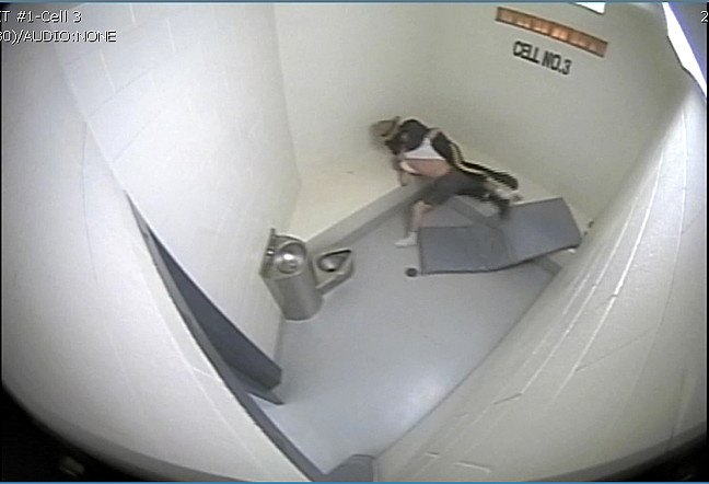 Bernard Naulalik (on top) wrestles with a member of the Nunavut RCMP in an Iqaluit detachment jail cell on the night of July 18, 2014. The Ottawa Police Service has begun an investigation into this incident caught on surveillance video after a public complaint was lodged April 20 alleging excessive force and public mischief by two Iqaluit officers who appear in the video. (RCMP SURVEILLANCE VIDEO CAPTURE)