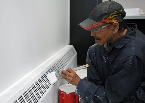 A new hamlet office for Arviat: Piglernerk Aupak, a painter and drywaller in Arviat, puts a final coat of paint on that hamlet's new office building, set to open in June. The new office is located next to the Kivalliq community's Government of Nunavut offices on its Airport Road. (PHOTO BY ERIC ANOEE)