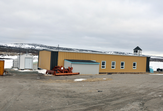 Blink and you might miss it: that small white building, to the left of Inukjuak’s Anglican church, is the community’s new morgue. The Kativik Regional Government has already installed the refrigerated facilities six Nunavik communities, while the rest of the region will see their own facilities put in place by the end of the year. The addition of morgues in the region is in response to community concerns and requests for facilities dedicated to holding the bodies of deceased Nunavimmiut until they are buried. (PHOTO BY SARAH ROGERS) 

