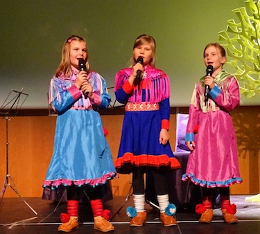 Three young Saami girls perform for participants in the International Congress on Circumpolar Health in Oulu, Finland, which lies at the southern edge of the Saami territory in northern Finland, Sweden, Norway and Russia. At the ICCH, indigenous health concerns were the subject of many research presentations. (PHOTO BY JANE GEORGE)