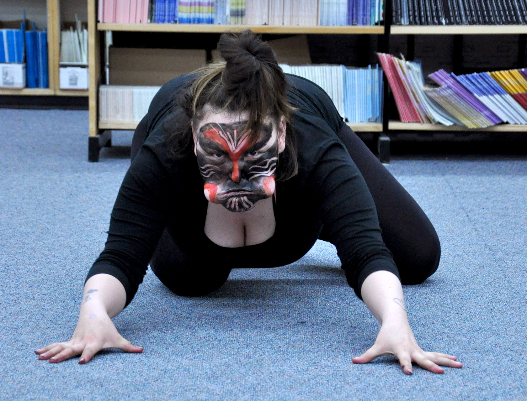 Aviaaja Peterson embodies an evil spirit as she skulks along the floor of the Nakasuk School library in Iqaluit June 29. Peterson traveled from Greenland to put on a Greenlandic Mask Dance workshop as part of the Alianait Arts Festival, which wraps up July 1. Much more music and entertainment still to come including an Inuit Music Jam today, June 30 at 2:30 in the big top tent and a circumpolar youth collaborative performance tonight in the Nakasuk gym. Full details available on the pocket schedule at www.alianait.ca. (PHOTO BY THOMAS ROHNER)