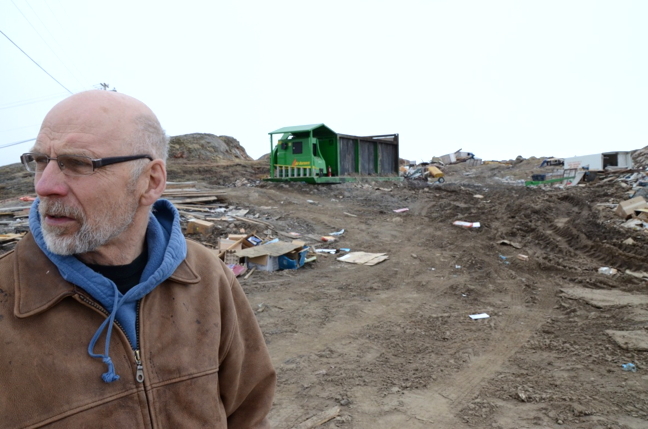 Jim Little stands in front of a green incinerator the city put on his site to remove some of the compostable material. (PHOTO BY DAVID MURPHY)