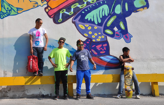 From left, Cie Taqiasaq, Parr Etidloie, Audi Qinnuayuaq and Latch Akesuk, stand in front of the completed mural they designed and painted onto the side of a building in downtown Toronto. (PHOTO BY SARAH ROGERS)