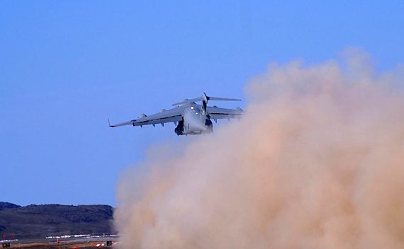 An RCAF Globemaster III transport plane takes off from the Iqaluit airport July 21 in a giant cloud of dust and sound. The plane makes such a deafening roar when it takes off, it's reported to have broken windows in Nunavut's capital. (PHOTO BY FIONA HUNT) 

