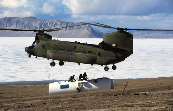 Helicopter pilot and captain Alexandre Adcock help co-workers hoist an empty fuel storage tank off the land at Skull Point, on Ellesmere Island, June 26, as part of Operation NEVUS. Every summer, Canadian Air Force members travel to Eureka to perform general maintenance on their station there — which houses the High Arctic Data Communications System — and the surrounding region. (PHOTO BY CLAYTON ERICKSON/CAF)