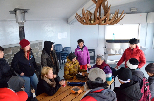 Alacie Joamie of Iqaluit, seated with red scarf, leads a qulliq lighting workshop at Sylvia Grinnell Territorial Park July 7. About 20 people turned up for the free event. (PHOTO BY DAVID MURPHY)
