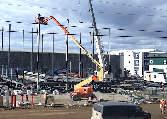 Construction on what has been called the City of Iqaluit's biggest single infrastructure project ever — the $40-million aquatic centre — has been ramping up this summer with the recent sealift delivery of construction materials. The energy-efficient facility, designed by Stantec and photographed under construction here on Aug. 20, will house a 25-metre lane pool, a leisure pool with water slide, a whirlpool, saunas and fitness facility as well as a gym, elders centre and concession stand. If construction goes as planned, Iqalungmiut could be swimming by December 2016, Iqaluit's recreation director Amy Elgersma told city councillors at a July 14 council meeting. (PHOTO BY THOMAS ROHNER)