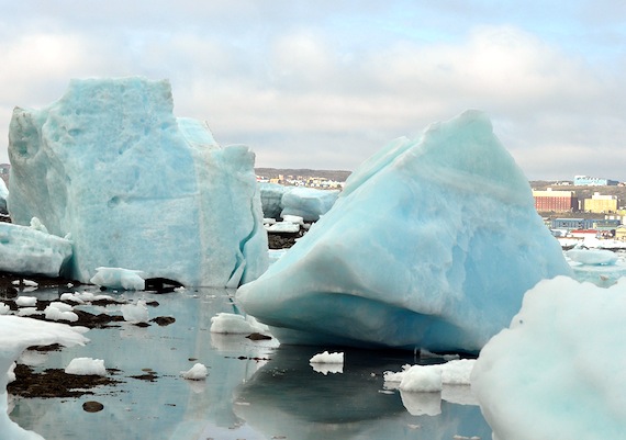 Iqaluit viewed through ice: some of the year's highest tides brought giant chunks of blue-green ice to Iqaluit this past weekend. Ice extent is greater than usual in Hudson Bay and Baffin Bay, the National Snow and Ice Data Cente said Aug. 5. Read more about the Arctic ice extent in 2015 and how it measures up on Nunatsiaqonline.ca. (PHOTO BY THOMAS ROHNER) 