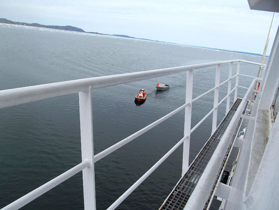 A zodiac from the CCGS George R. Pearkes tows a boat, which was drifting in Ward Inlet after its engines failed, towards the icebreaker Aug. 21 about 50 nautical miles from Iqaluit. Icebreaker personnel hauled the boat aboard their vessel and carried the boat and its four-person crew back to Iqaluit later that day. Read more Aug. 27 on Nunatsiaqonline.ca. (PHOTO COURTESY OF THE COAST GUARD)