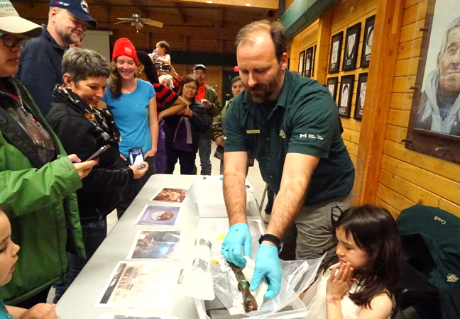 Filippa Ronca of Parks Canada shows off a belayer from the HMS Erebus to residents of Cambridge Bay gathered at the Luke Novoligak community hall. This past summer, Parks Canada divers, with assistance from the Royal Canadian Navy and the Arctic Research Foundation, used laser technology to record detailed three-dimensional interior and exterior views of the Sir John Franklin wreck and also brought back more artifacts including dishes and a belt buckle. The Erebus and HMS Terror both sank in Victoria Strait, north of Queen Maud Gulf, during Franklin's unsuccessful voyage through the Northwest Passage in 1845. HMS Terror has yet to be found. (PHOTO BY JANE GEORGE)