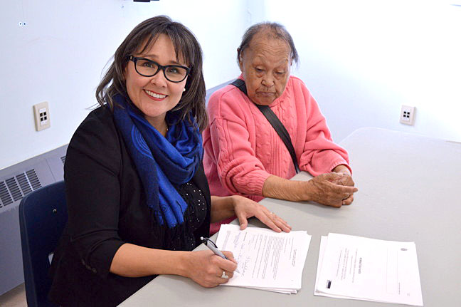 Incumbent Nunavut MP Leona Aglukkaq is joined by Iqaluit elder Annie Shoo, 84, as she signs registration papers to make her the official Conservative candidate for the upcoming federal election Oct. 19. In a brief press conference outside the Elections Canada office in Iqaluit Sept 3, Aglukkaq promised to continue investing in economic development in Iqaluit, and the North. Three other candidates have announced their desire to challenge Aglukkaq and take the Nunavut seat: Liberal Hunter Tootoo, New Democrat Jack Anawak and Spencer Rocchi, who will run for the Green Party. (PHOTO BY STEVE DUCHARME)