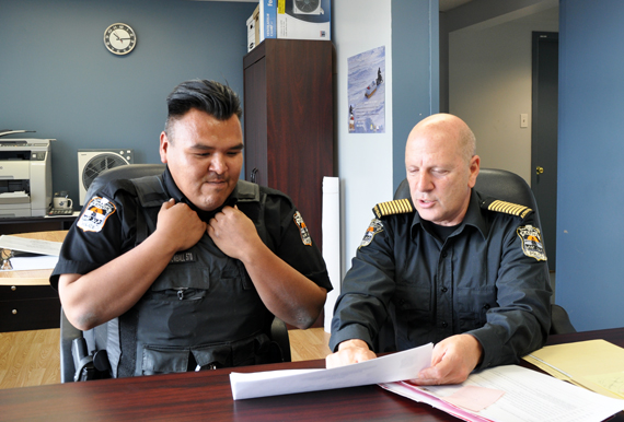 KRPF chief Michel Martin, right, sits down with officer Sammy Snowball, one of the force’s few Inuit members. “They’re aren’t many, but we have a few very good Inuit police officers,” Martin said. “And they’ll take over in the future.” (PHOTO BY SARAH ROGERS)