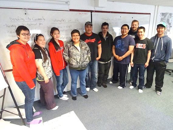 Environmental Technology students at Nunavut Arctic College in Cambridge Bay stand Oct. 3 in front of a board showing the results of a community meeting organized by Ikaarvik. Ikaarvik, Inuktitut for “the bridge,