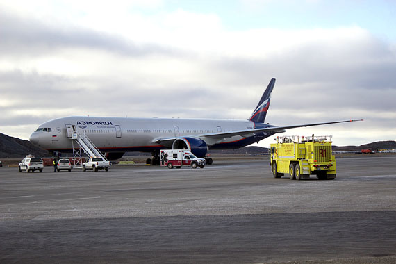 An Iqaluit ambulance stands in front of Aeroflot flight 107 on the airport tarmac Oct. 5, shortly after 2 p.m., when the flight was diverted to Iqaluit after a passenger suffered a medical emergency. The Boeing 777-300ER, en route from Moscow to Los Angeles, took off again after about two hours, with the passenger remaining at Qikiqtani General Hospital. (PHOTO BY BRIAN TATTUINEE)
