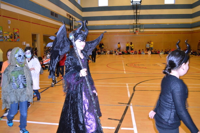 Maleficent, otherwise known as Leila Wilman, parades around the gym at Joamie School Oct. 30 during the Iqaluit school's annual Halloween assembly. Every year, students from Joamie parade the gym, grade by grade, to show off their costumes. This year, the teachers all dressed up as minions from Despicable Me and Sonja Lonsdale was Gru, their overlord. Lonsdale said they always have spare costumes so students who don't have one can borrow one if they choose to. (PHOTO COURTESY SONJA LONSDALE)