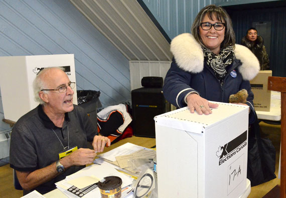 Leona Aglukkaq, the incumbent MP for Nunavut, casts her vote just after 11 a.m. Oct. 19 after standing in line at the Iqaluit Cadet Hall polling station. Polls opened in Canada's 42nd general election at 9:30 a.m. within the eastern time zone, and by about 10:15 a.m., a long line of voters were queuing up outside the polling station in Iqaluit.
