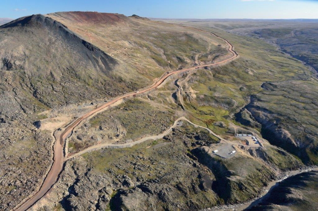 Iron ore from the Mary River mine is currently trucked from the top of Deposit 1 of the Naluujaak pit, top left, downhill to an ore crusher. Under its proposed Phase II, Baffinland hopes to ramp up its ore hauling and ship 10 months of the year. (PHOTO COURTESY BAFFINLAND IRON MINES)