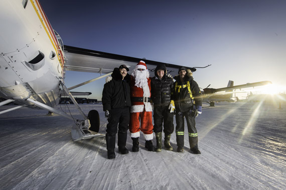 A tradition continues: Johnny May’s 50th annual candy drop in Kuujjuaq might have been postponed from Christmas Day this year due to bad weather, but Nunavik’s famed pilot made up for it Dec. 29 when he dropped gifts over an estimated 1,000 Kuujjuamiut. May, pictured second from right, had help from Santa himself, who flew in this year’s candy drop, along with volunteers Bryan York, far left, and Bruce Turner, far right. While 2015 was meant to be the final candy drop for May, who retires this year, he’s promised to fly one more candy drop in Kuujjuaq on Christmas Day 2016. (PHOTO BY TRISTAN BRAND/MARY RUSTON)


