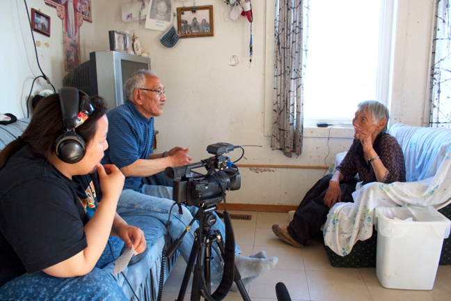 Nanivara researcher Jennifer Ullulaq, in headphones, interviews an elder in Gjoa Haven. Researchers from the Nanivara heritage research project, which connects youth and elders for the purpose of collecting and recording traditional knowledge, were in Vancouver last week to present the details of their project at the annual ArcticNet conference. Ullulaq and her colleagues are hoping also to impress upon the world's foremost Arctic scientists and researchers that Inuit Qaujimajatuqangit deserves more than quaint, token inclusion in a project but ought to be a main driving element instead. Read more about the project, and their presentation to ArcticNet, later on nunatsiaqonline.ca. (PHOTO COURTESY NANIVARA)
