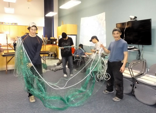 Igloolik residents enrolled in a four-week small vessel operator program learn to mend nets this month in that north Baffin community. The program, offered through funding from the Nunavut Fisheries and Marine Training Consortium and the Hamlet of Igloolik, ran from Nov. 23 to Dec. 18 and included 10 male and female students. From instructor Wayne Tucker, they learned how to safely operate small craft on Nunavut waters including basic First Aid, marine radio operator protocols and how to deal with emergencies. (PHOTO COURTESY NANCY MACDONALD)
