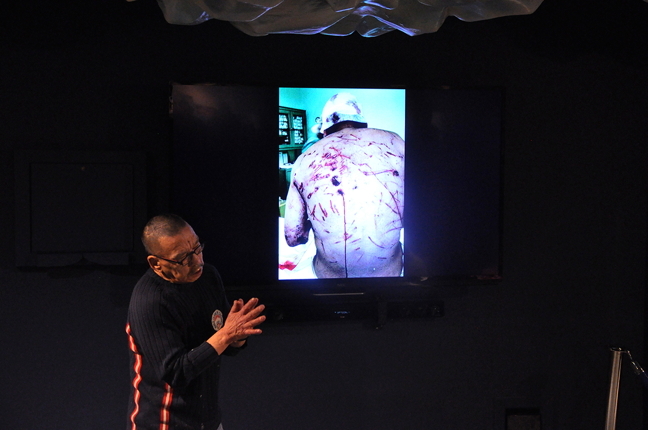 Kootoo Shaw uses his hands Jan. 12 to describe how a polar bear sunk its claws into his flesh outside Kimmirut in 2003, leaving his back covered in scratches, gouges and one two-inch gaping hole. About 50 Iqalungmiut filled the Unikkaarvik Visitors Centre Jan. 12 as Shaw regaled them with his gruesome tale of surviving the attack. Find out what happened to Shaw later, on Nunatsiaqonline.ca. The visitors centre will be holding free talks this month every Tuesday at 7:30 p.m. Long-time community leader Jack Anawak will speak Jan. 19 on