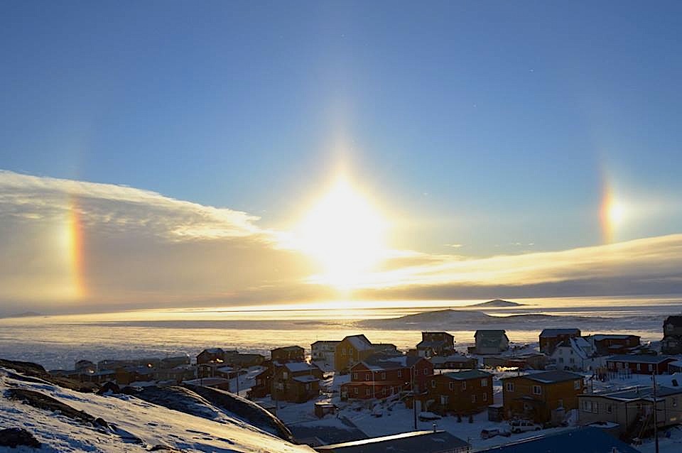 A sundog appears over Iqaluit Jan 20. Sundogs, sometimes called parhelions, occur when sunlight refracts off plate-shaped ice crystals and tend to be most visible when the sun is closest to the horizon, according to www.timeanddate.com. The parts closest to the sun often appear more red in colour and the parts further away often appear blue or green. (PHOTO BY STEVE DUCHARME)