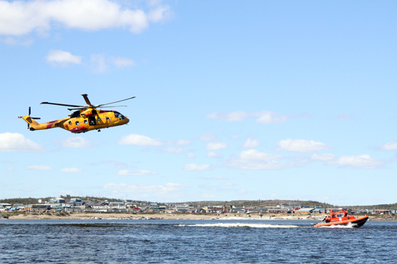 A Cormorant helicopter from Nova Scotia flies above a search vessel on Kuujjuaq’s Koksoak river as part of a 2014 simulated rescue scenario. Kuujjuaq officials hosted the Northern SAR Roundtable met in the Nunavik community last week. (PHOTO COURTESY OF THE KRG)
