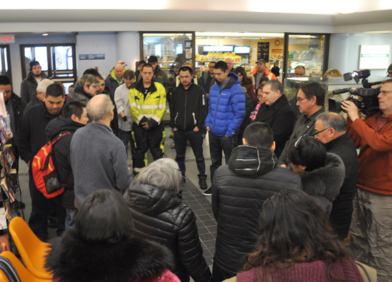 Rev. Mike Gardener leads F/V Saputi crew members in a seafarer’s prayer upon their return to the Iqaluit airport Feb. 26. (PHOTO BY SARAH ROGERS)