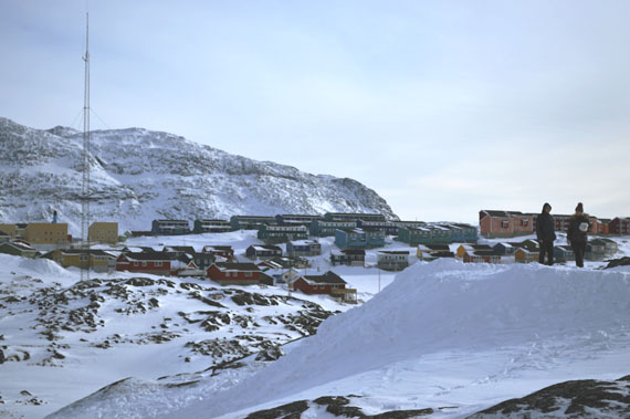 After two days of missed flights and delayed events, the weather finally seems to be cooperating in Nuuk, Greenland for the 2016 Arctic Winter Games. Here, two spectators take in the view on the east side of the city March 9. Just below them, athletes compete in ski and snowshoe races at one of two designated areas in Nuuk for outdoor games. It's currently 0C in Greenland's capital, with the forecast calling for mostly clear skies for the remainder of the day with a low of -3C. (PHOTO BY STEVE DUCHARME)