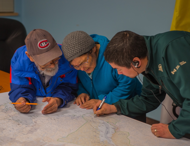 Ukkusiksalik National Park Manager Monty Yank takes notes as Honore Aglukka and his wife Elizabeth share their knowledge and experiences from the Wager Bay area. (PHOTO BY JOVAN SIMIC/PARKS CANADA)