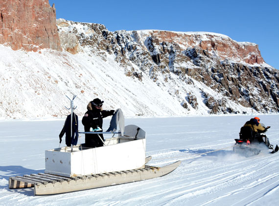 Adrian Dzioba, a teacher in Arctic Bay, demonstrates the art of extreme ironing during an outing with fellow teachers John Nzakamulilo and Greg Stevenson. Dzioba describes it as a