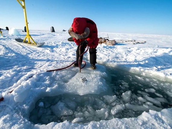 This photo, emailed to us anonymously, appears to show former Nunavut MP Leona Aglukkaq cutting through ice prior to some winter scuba diving near Gjoa Haven.