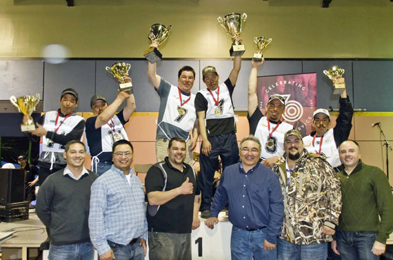 Ivakkak's top three winners hoist their trophies at an awards ceremony at the Kuujjuaq Forum April 12, attending by Makivik Corp. officials. Tasiujaq's Willie Cain Jr. and Daniel Cain Annahatak, centre, won the 2016 event with a total time of 30 hours and 55 minutes. In second place, Peter Ittukallak and Putugu Iqiquq of Puvirnituq, at left, finished in 31 hours and 42 minutes, while Kuujjuaq mushers George Kauki and Jikka Cain Snowball, at right, finished in third place in 32 hours and six minutes. (PHOTO BY P. DUNNIGAN/IVAKKAK)