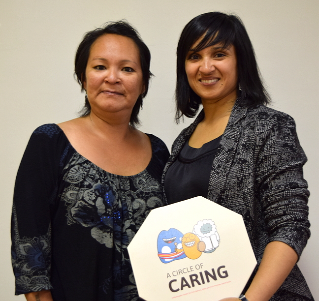 Tungasuvvingat Inuit's Eva Cameron, left, and Mohini Athia, director of English language programs and services at Centre Ontarien pour la prevention des agressions pose for a photo May 19 at a TI community feast in Ottawa. Cameron partnered with COPA to narrate educational videos in Inuktitut called 