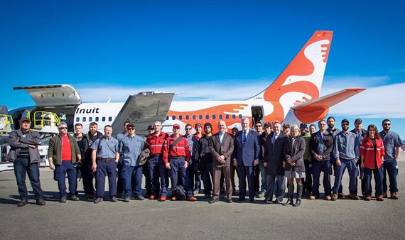 Quebec firefighters stand May 10 with Quebec Premier Philippe Couillard by an Air Inuit jet, chartered for the journey to Fort McMurray, where they'll help fight raging wildfires that have forced the evacuation of the Alberta city. Quebec is sending more than 40 specialized firefighters from the La Société de protection des forêts contre le feu to Fort McMurray. (PHOTO COURTESY OF THE QUEBEC GOVERNMENT)