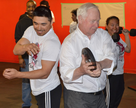 Salluit athlete Larry Thomassiah, left, leads the Governor General of Canada, David Johnston, through a workout at Salluit’s fitness centre May 6 during his day-long visit to the Nunavik community. During the governor general’s visit, Johnston spent time with Thomassiah and other members of the Salluit Running Club, to talk about the benefits of physical activity for youth in Nunavik. Johnston visited eight Arctic communities as part of an Arctic tour earlier this month. (PHOTO BY ABDULLAH KAFASHE)