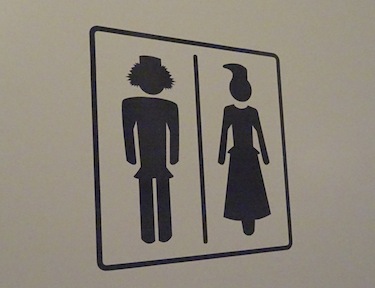 The images on the bathroom door of the Máttabiegga Giellabeassi language nest show silhouettes of men and women in traditional Saami outfits. (PHOTO BY JANE GEORGE)