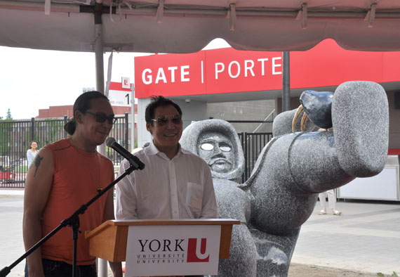 Nunavut artists Ruben Komangapik, left and Koomuatuk (Kuzy) Curley, right, talk about Ahqahizu, their 26-tonne creation during its unveiling at Toronto’s York University June 21, for National Aboriginal Day. (PHOTO BY SARAH ROGERS)