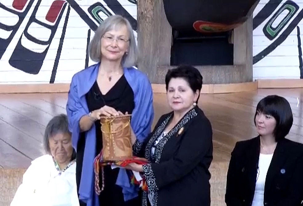 Marion Buller, a First Nations judge who sits on the B.C. provincial court (standing) who will serve as chief commissioner of the federal government’s National Inquiry into Missing and Murdered Indigenous Woman, receives a gift from an Algonquin elder at the inquiry’s Aug. 3 launch in Gatineau, Que. On the left is Inuit elder Sally Webster and on the right sits Qajaq Robinson, one of the other four commissioners. The first phase of the inquiry will cost nearly $54 million and run from Sept. 1, 2016 until Dec. 31, 2018. At the same time, Justice Canada will give provinces and territories $11.67 million over three years to fund family liaison services and another $4.5 million for victims services. Read more on Nunatsiaqonline.ca (VIDEO CAPTURE)