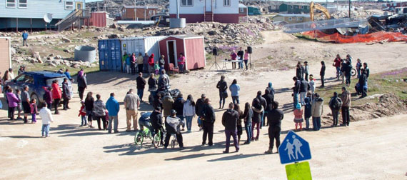 Cape Dorset residents gather near the site of the former Peter Pitseolak high school July 21, which burned down in 2015, as part of a ceremony and memorial for the community institution. Crews are finally clearing the last of the debris from the site, which may eventually become the site of the community's new health care centre. (PHOTO BY CLAUDE CONSTANTINEAU)