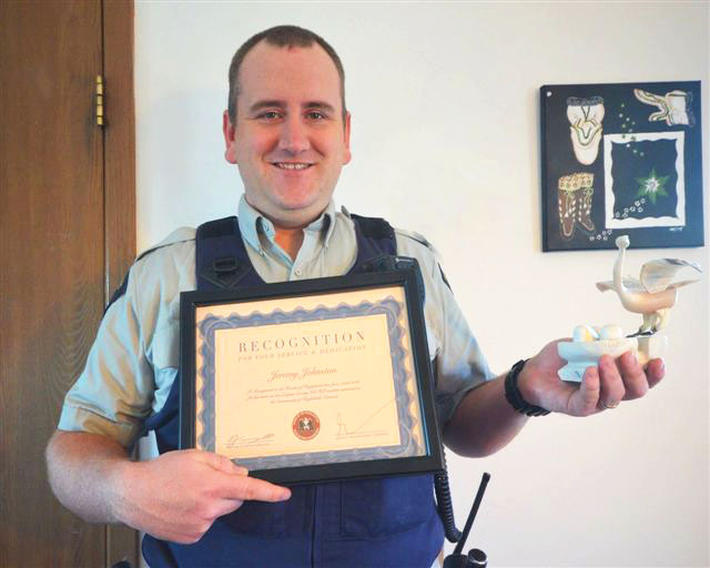 Nunavut RCMP Cst. Jeremy Johnston holds up a sculpture and certificate recognizing him for his service to policing in Nunavut, presented to him by the hamlet of Kugluktuk this past week. Johnston is transferring out of territory after working for three and half years in the Kitikmeot community, the RCMP’s longest-serving local member. Cst. Johnston and his wife, a community home care nurse, first moved to Nunavut in 2013, after previously being stationed in the Maritimes and in Alberta. “Coming up north and being posted in Kugluktuk was one of the best decisions we have ever made,” Johnston said. “As soon as we arrived in the Kugluktuk we felt like we were accepted with open arms. Kugluktuk is always going to be very special for us, along with our 4 year old son who has spent the majority of his life up here.” (PHOTO COURTESY OF THE RCMP)