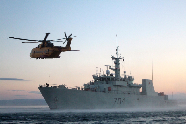 The HMCS Shawinigan takes part in a hoist rescue exercise with technicians aboard a CH-149 Cormorant in Koojesse Inlet off Iqaluit during Operation Nanook 2014. The Royal Canadian Navy announced Aug. 11 that HMCS Shawinigan is returning north for seven weeks of deployment with the HMCS Moncton to 