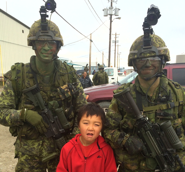 Canadian Armed Forces personnel, and their potential new recruit Jackie Nakoolak, near the community hall in Rankin Inlet Aug. 29. Soldiers were in the Kivalliq this week taking part in Arctic training exercises as part of the annual Department of National Defence's Operation Nanook. (PHOTO BY NOEL KALUDJAK)