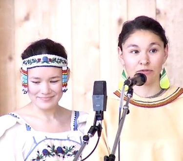 Throat singers Charlotte and Abby Carleton prepare to perform towards the end of the Aug. 3 launch of the MMIWG inquiry. (VIDEO CAPTURE)