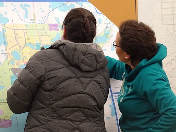 Cambridge Bay Mayor Jeannie Ehaloak, at right, discusses a map from the Cambridge Bay Community Plan, 2015 to 2035, at a recent open house held at the hamlet office, which drew about 20 residents. (PHOTO BY JANE GEORGE) 