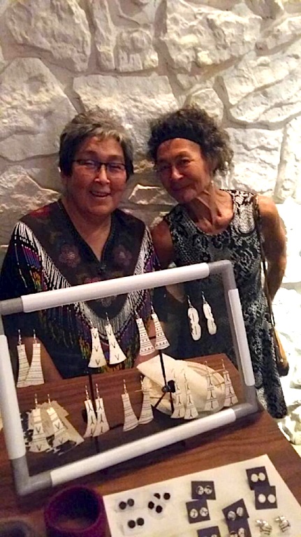 Elisapi Davidee Angingmiuq and Aaju Peter stand behind a display of Angingmiuq's creations Sept. 11 at Nunavut's TIFF reception. (PHOTO COURTESY OF NACA)