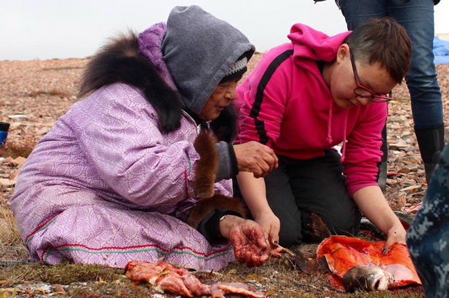 Elders share their knowledge with youth as part of the Cambridge Bay Arctic char tagging project. The project, intended to increase understanding of Arctic char migrations around Cambridge Bay, brought youth and elders to Ikaluktuuq late last month to share knowledge and stories about Arctic char. (PHOTO COURTESY OF THE CB ARCTIC CHAR TAGGING PROJECT)