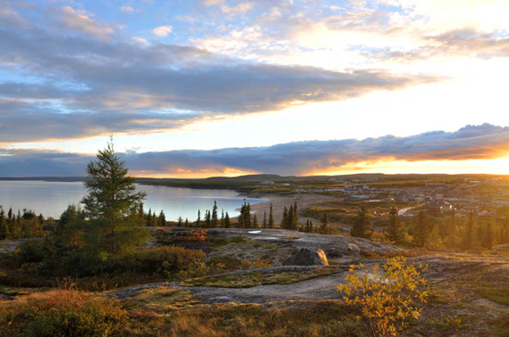 Fall colours light up the hills overlooking Kuujjuaq last week as the sun sets over the Koksoak river. Kuujjuamiut have been taking advantage of the region's brief autumn, which continues to offer above-seasonal temperatures and plenty of berries for the picking. (PHOTO BY SARAH ROGERS)