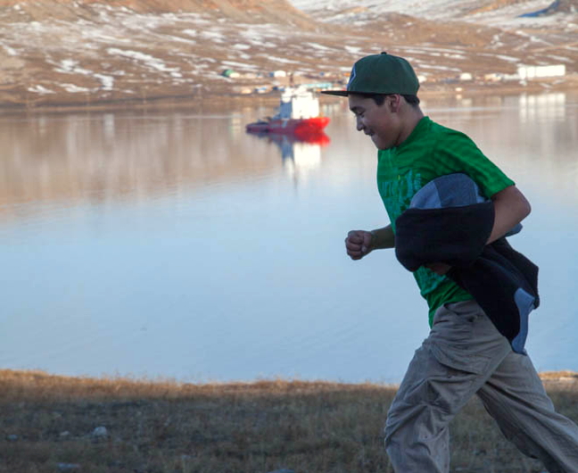 An Inuujaq School student participates in a Sept. 29 Terry Fox Run through Arctic Bay to celebrate the famous Canadian's attempt to run across Canada after losing a leg to cancer during his Marathon of Hope in 1980. The cancer eventually spread and he died in 1981 but not before running more than 5,300 kilometres, from St. John's, Nfld., to Thunder Bay, Ont., and raising $1.7 million for cancer research. Every year, schools across the country celebrate Terry Fox's legacy by running, walking and raising money for the Canadian Cancer Society. And it just so happens, that's the CCGS Terry Fox in the bay. (PHOTO BY CLARE KINES)