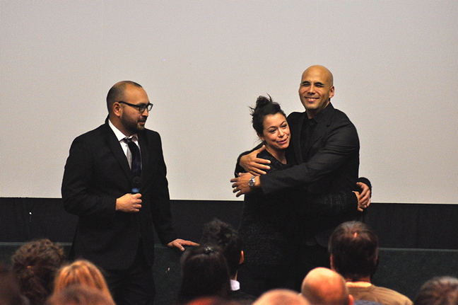 Director Kim Nguyen, right, and Emmy Award winning actress Tatiana Maslany share a hug in front of a capacity crowd at the Astro Theatre in Iqaluit Oct. 28 before the Nunavut première of Two Lovers and a Bear. The magic realism film, shot in Iqaluit and Apex, had its world premiere at the Cannes Film Festival and its Canadian premiere in September at the Toronto International Film Festival. Read more about their Nunavut homecoming later on Nunatsiaqonline.ca. (PHOTO BY THOMAS ROHNER)